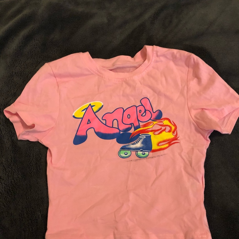 a pink crop top that says angel on it 👼